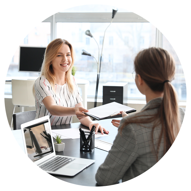 women handing clipboard to agent