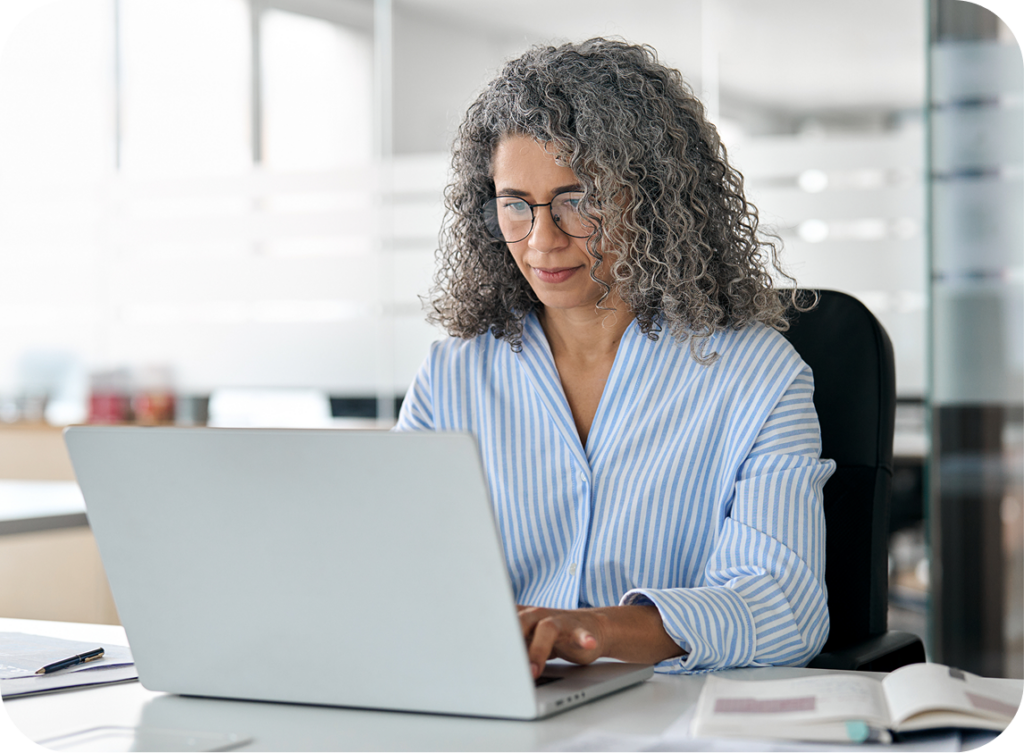women typing and working on computer in office